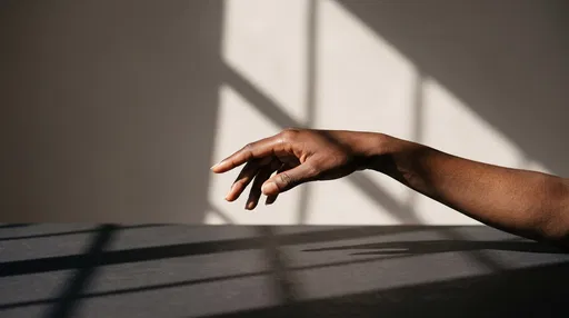 Poised Dark Hand Over Shadowed Tabletop
