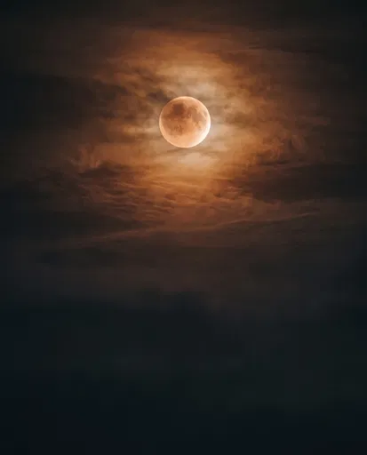 Glowing Blood Moon Through Night Clouds