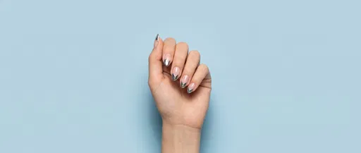 Manicured Hand With Silver Heart Nails