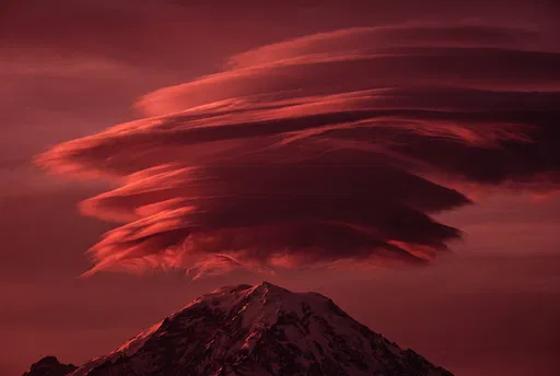Crimson Lenticular Clouds Over Mountain Peak
