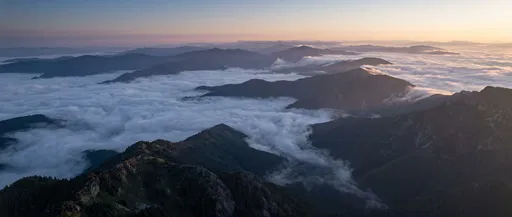 Aerial View of Misty Mountains at Sunrise