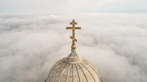 Orthodox Cross Dome Above Clouds