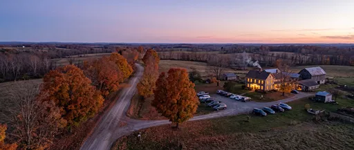 Aerial Twilight View of Autumn Farmhouse Gathering