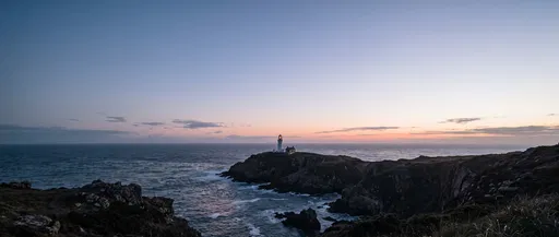 Coastal Lighthouse on Rocky Headland at Dusk