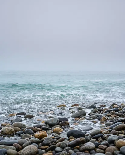 Wet Pebble Beach With Misty Ocean Horizon