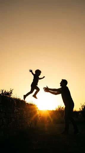 Child Jumping into Father's Arms at Sunset