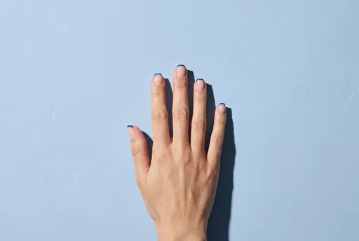 Hand With Blue Micro French Manicure