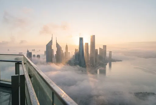 Misty Sunrise Over Coastal Skyscrapers