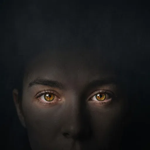 Luminous Hazel Eyes in Dark Shadow