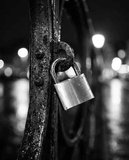 Padlock on Wet Iron Bridge Railing