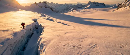 Backcountry Skier Jumping Glacier Crevasse at Sunset