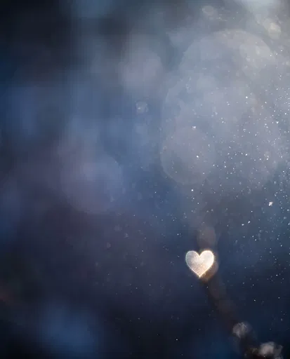 Glowing Heart Against Blue Winter Bokeh