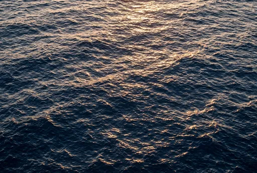 Golden Sunlight Reflecting on Deep Ocean Waves