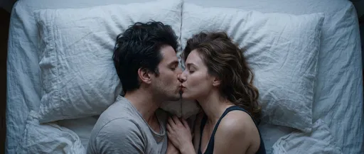 Overhead View of Couple Kissing in Bed