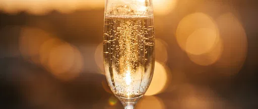 Golden Champagne Flute With Warm Bokeh