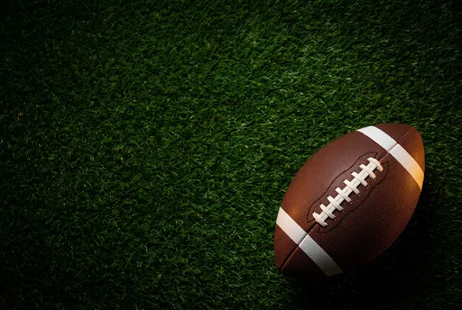 American Football on Dark Green Turf