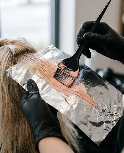 Stylist Applying Peach Pink Hair Dye