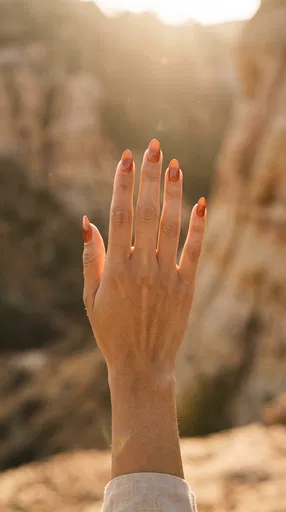 Backlit Hand with Terracotta Almond Nails