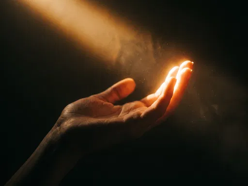 Upturned Hand in Warm Light Beam