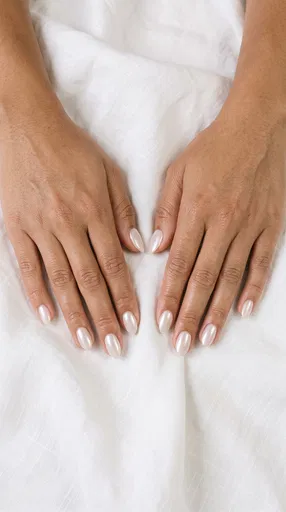 Hands With Pearl Glazed Almond Nails