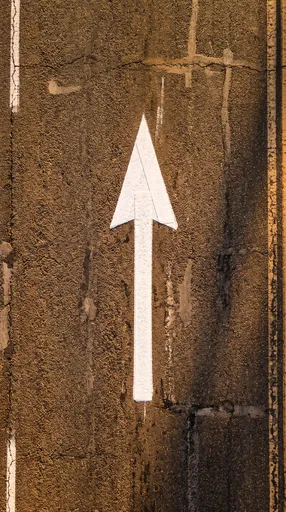 Overhead White Traffic Arrow on Asphalt