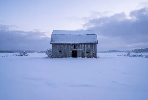 Weathered Wooden Barn in Snowy Meadow