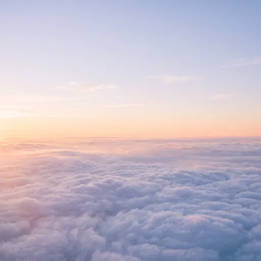 Pastel Sunrise Above Sea of Clouds