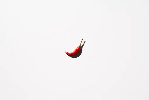 Single Red Chili Pepper on White