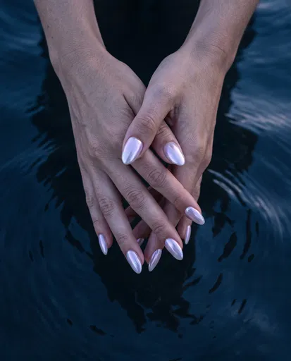 Pearlescent Manicure Hands Over Dark Water