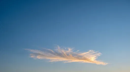 Golden Cirrus Cloud in Clear Blue Sky