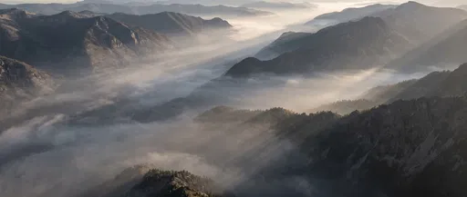 Misty Mountain Valley with Morning Sunbeams