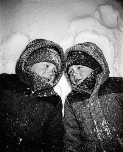 Two Children Lying in Snow