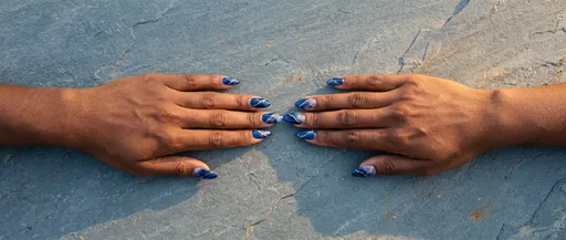 Hands Showing Blue Marble Almond Nails