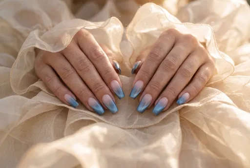 Hands With Blue Ombre Manicure On Organza