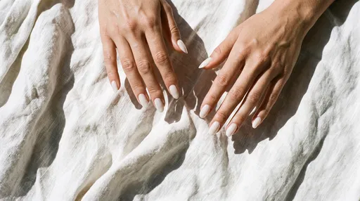 Manicured Hands on Crumpled White Linen