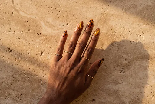 Hand With Tortoiseshell and Cat Eye Nails