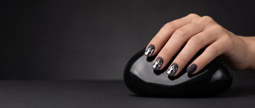 Manicured Hand With Black Chrome Flame Nails