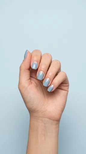 Hand With Blue Half-Moon Manicure