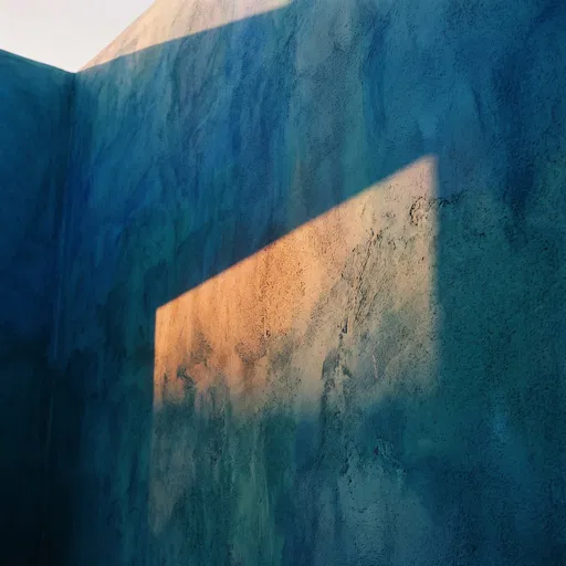 Golden Sunlight on Blue Plaster Wall