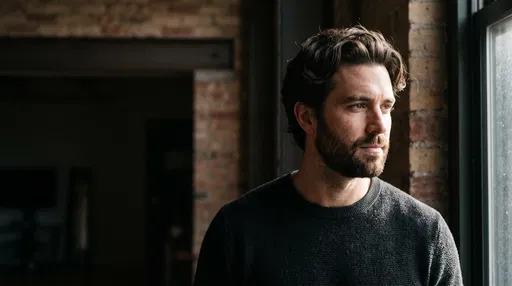 Bearded Man Looking Out Loft Window