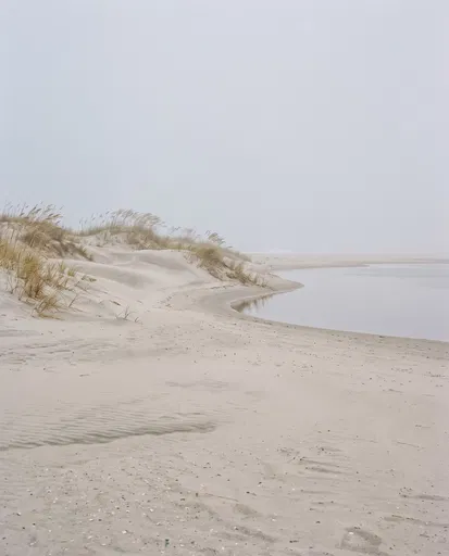 Misty Coastal Sand Dunes and Calm Lagoon