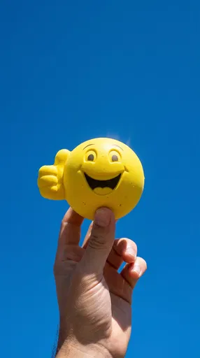 Hand Holding Thumbs Up Smiley Ball