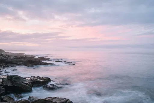 Misty Pastel Dawn Over Rocky Coast