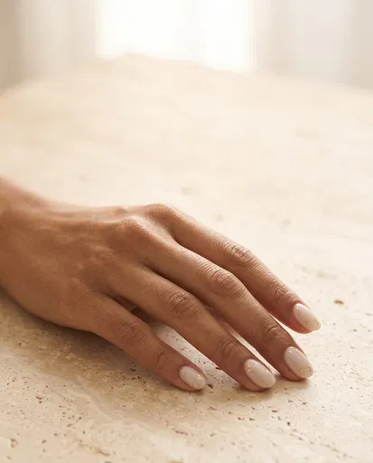 Hand With Milky Gold Flake Manicure