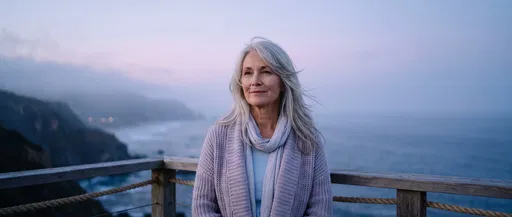 Mature Woman on Coastal Balcony at Dusk