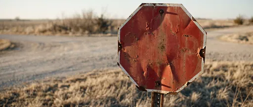 Weathered Blank Red Octagonal Sign at Crossroads