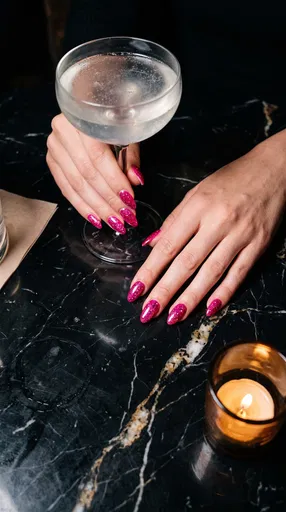 Hands With Pink Glitter Nails Holding Cocktail