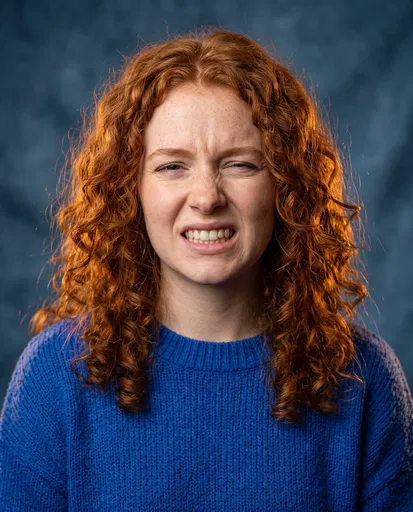 Red-Haired Woman Making Awkward Grimace