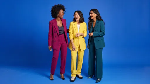 Three Diverse Women Laughing in Colorful Suits