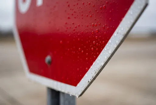 Close-Up of Wet Red Road Sign